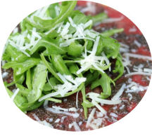 Beef carpaccio served with rocket and parmesan shavings.